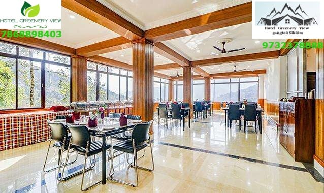 In-house restaurant with panoramic valley view windows at Hotel Greenery View